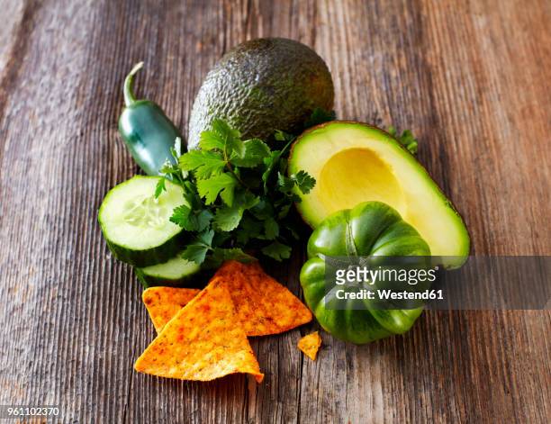 avocado, tortilla chips, green tomato, jalapenos, cucumber, parsley - slätpersilja bildbanksfoton och bilder