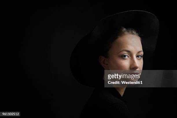 portrait of young woman against black background - high contrast bildbanksfoton och bilder