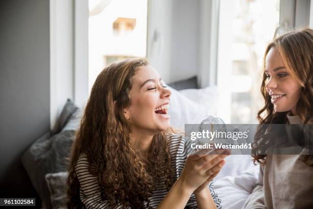 two happy teenage girls with snow globe - funny snow globe - fotografias e filmes do acervo