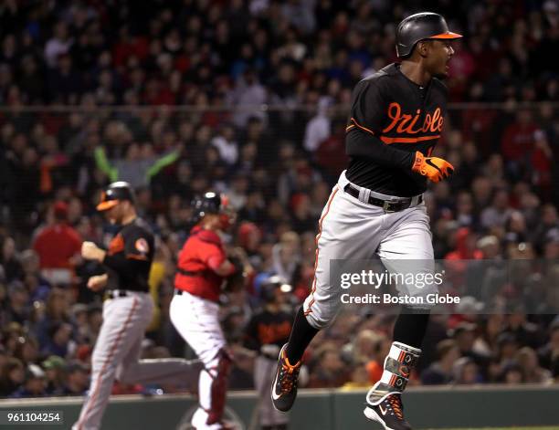 Baltimore Orioles first baseman Chris Davis and Baltimore Orioles third baseman Danny Valencia score on a single by Baltimore Orioles center fielder...