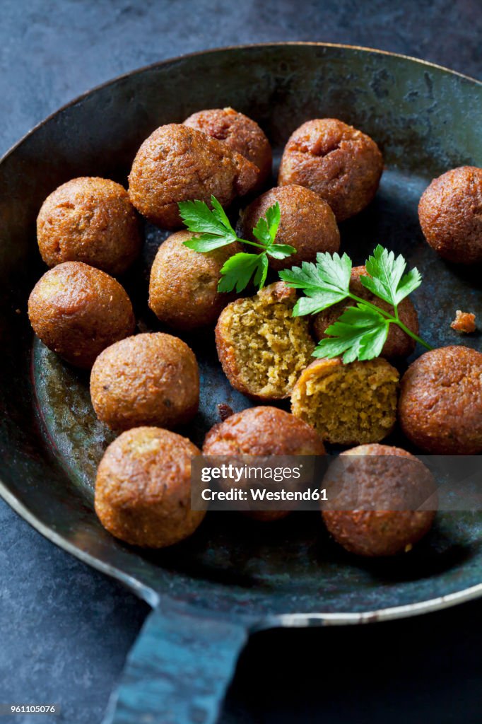 Vegan vegetable balls and parsley leaf in pan