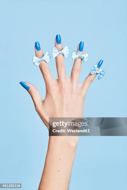 close-up of bow ties on woman's fingers - nagellack stock-fotos und bilder