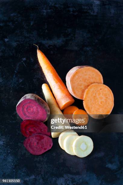 sliced root vegetables on dark ground - turnip stock pictures, royalty-free photos & images