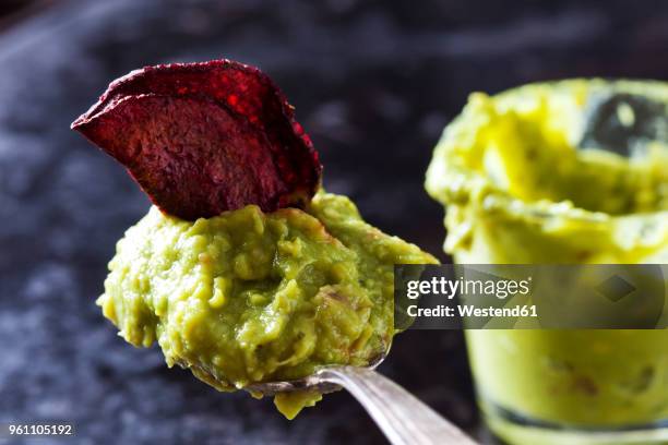 spoon of guacamole and betroot chip - vegetable chips stock pictures, royalty-free photos & images