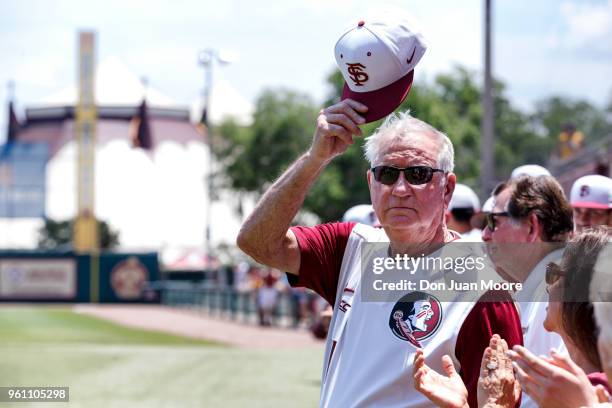 Head Coach Mike Martin of the Florida State Seminoles tilt his cap to the fans while being honored as college baseball's all-time winningest coach...