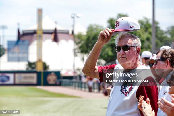 Head Coach Mike Martin of the Florida State Seminoles tilt his cap to the fans while being honored as college baseball's all-time winningest coach...