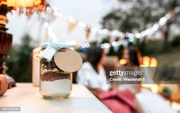 close-up of wedding gift jar with ingredients to make homemade chocolate cookies - wedding gift stockfoto's en -beelden