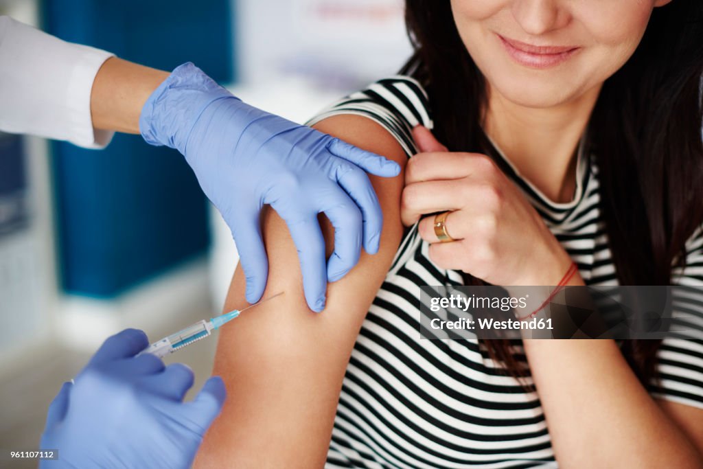 Woman receiving an injection in her arm