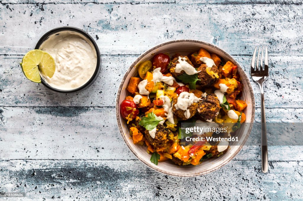 Vegetarian bowl with sweet potato, tomato and falafel, yogurt dip and parsley