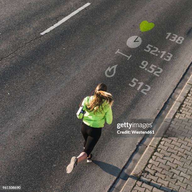 young woman running on a street with data - running man heartbeat stock-fotos und bilder