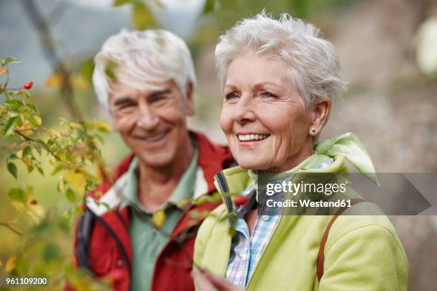 portrait of happy senior woman with partner in the background - beweglichkeit stock-fotos und bilder