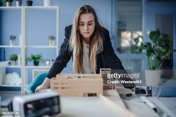 architect looking at architectural model in office - architekturmodell stock-fotos und bilder