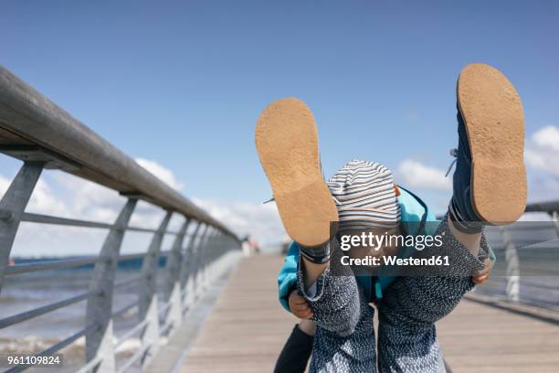 mother and son playing on jetty - timmendorfer strand stock-fotos und bilder