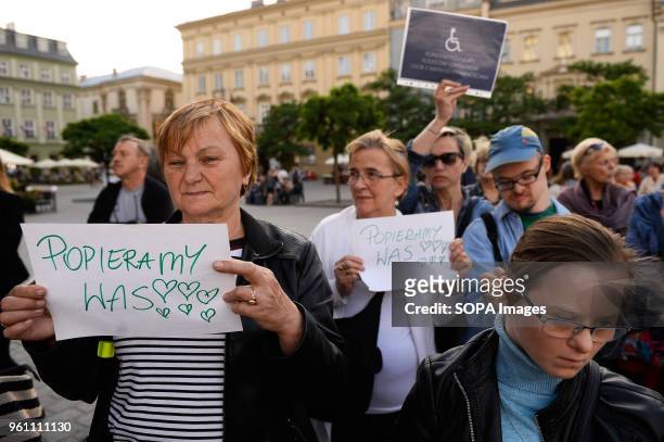 Woman holds a banner saying " we support you " during a protest to show solidarity for the ongoing protest inside the Parliament by parents of...