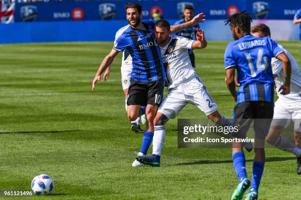 Montreal Impact midfielder Ignacio Piatti collides with Los Angeles Galaxy midfielder Perry Kitchen and lets the ball get away during the LA Galaxy...