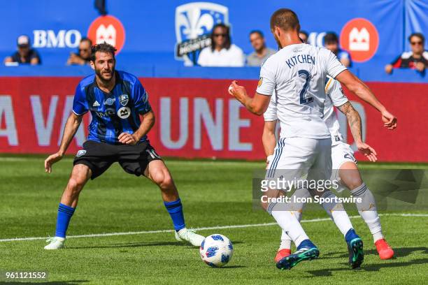 Los Angeles Galaxy midfielder Perry Kitchen gains control of the ball in front of Montreal Impact midfielder Ignacio Piatti during the LA Galaxy...