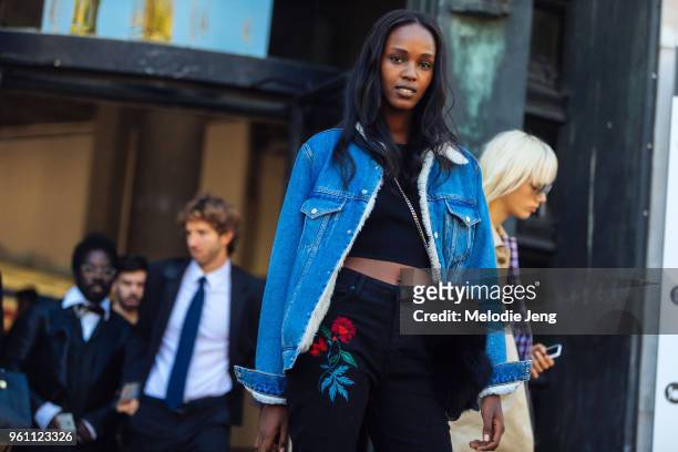 Leila Nda wears a lined denim jacket and black jeans with a floral stitch after the Redemption show at Palais de Tokyo on October 04, 2016 in Paris,...