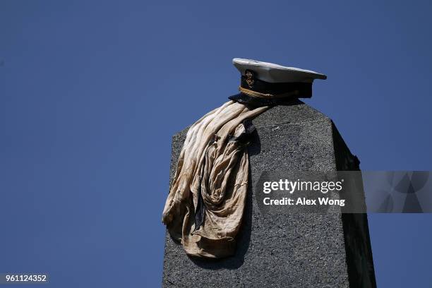 An upperclassman's hat is placed on top of the Herndon Monument after the annual Herndon Monument Climb May 21, 2018 at the U.S. Naval Academy in...