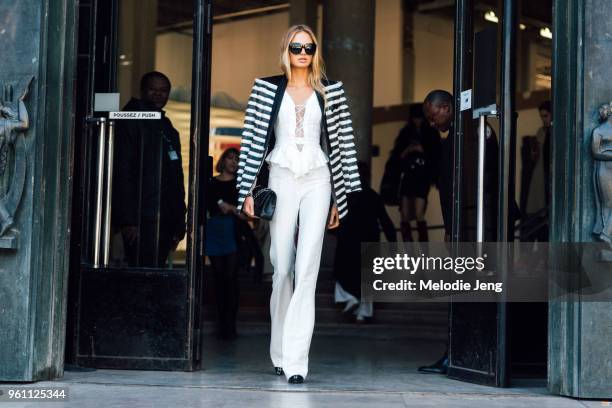 Victoria's Secret Angel model Romee Strijd wears a black and white striped blazer, white corset-style top, and black pants after the Redemption show...