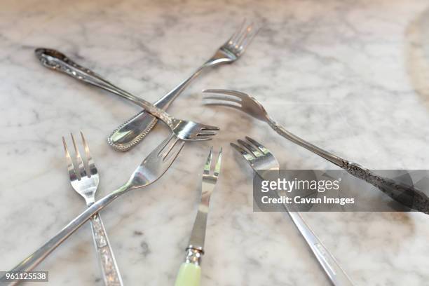 high angle view of various forks on table - carvery stockfoto's en -beelden
