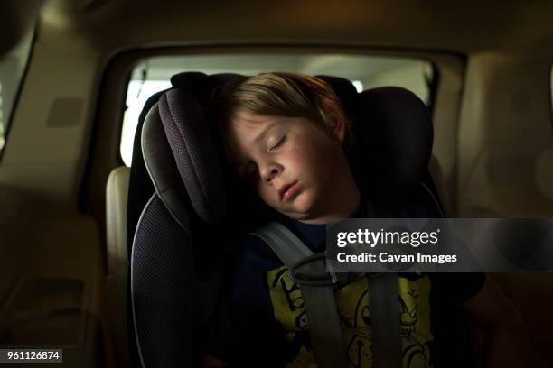 boy sleeping while traveling in car - sleeping in car foto e immagini stock