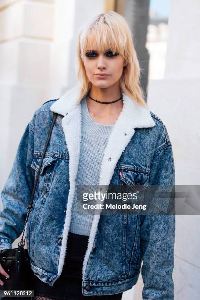 Model Elise Agee wears a shearling-lined denim jacket and gray sweater after the Louis Vuitton show at Place Vendome on October 05, 2016 in Paris,...