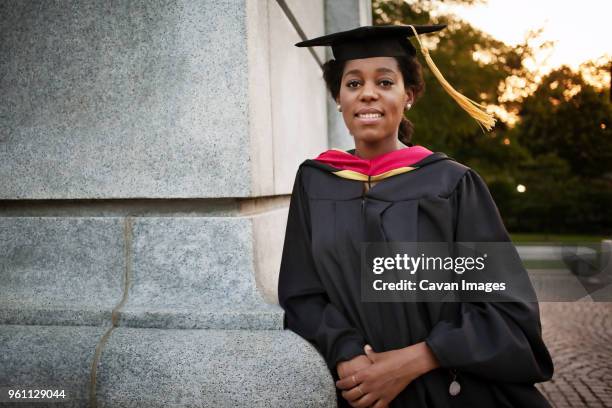 portrait of woman wearing graduation gown - black woman graduation stock pictures, royalty-free photos & images