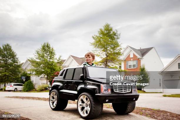 boy in eclectic car - toy car stock pictures, royalty-free photos & images