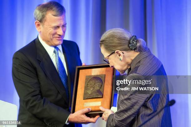 Supreme Court Justice Ruth Bader Ginsburg receives the American Law Institute's Henry J. Friendly Medal from US Supreme Court Chief Justice John...