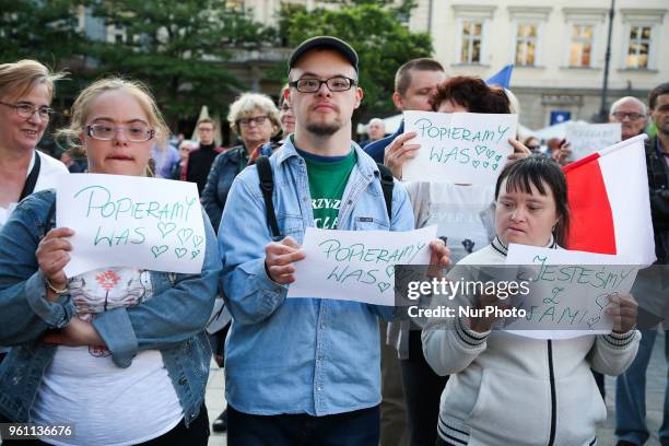 Disabled people hold a banner saying 'We support you' during 'Solidarity with disabled' rally at the Main Square in Krakow, Poland on 21 May, 2018....