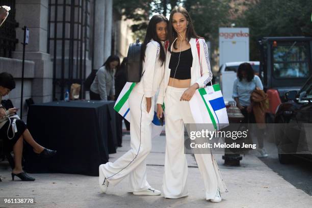 Dominican models Manuela Sanchez and Hiandra Martinez wear white Tory Sport tracksuits and sneakers after the Tory Burch show during New York Fashion...