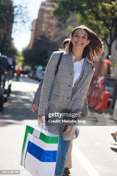 Model Mckenna Hellam laughs and wears a gray patterned blazer after the Tory Burch show during New York Fashion Week Spring/Summer 2018 on September...