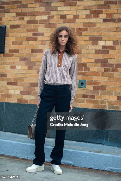 Model Estella Brons wears a patterned top, black pants, Celine shoes, Dior bag during New York Fashion Week Spring/Summer 2018 on September 9, 2017...