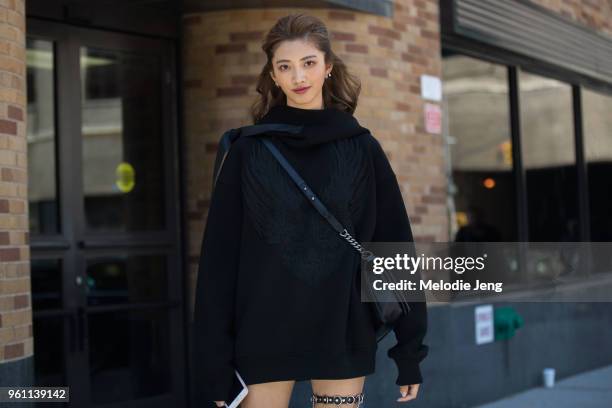 Taiwanese model I-Hua Wu wears a oversized black hoodie and bag during New York Fashion Week Spring/Summer 2018 on September 9, 2017 in New York City.