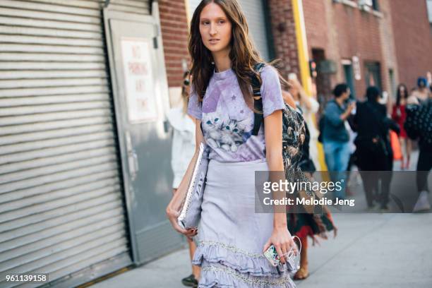 Model Jay Wright wears a purple shirt with cats and a purple skirt during New York Fashion Week Spring/Summer 2018 on September 9, 2017 in New York...