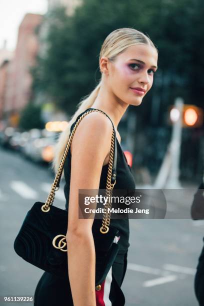 Model Noel Berry in purple eyemakeup after the Area show and carrying a Gucci bag during New York Fashion Week Spring/Summer 2018 on September 9,...