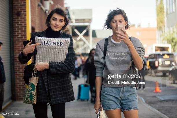Models Ratner, Amber Witcomb during New York Fashion Week Spring/Summer 2018 on September 9, 2017 in New York City. Ratner carries a Starbucks paper...