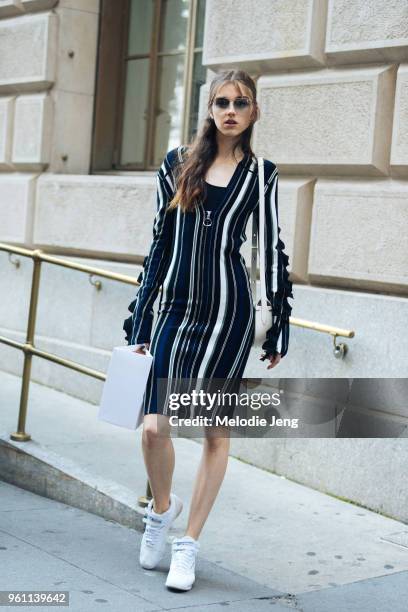 Model Jay Jankowska wears a blue 3.1 Phillip Lim stripe dress and white Reebok sneakers during New York Fashion Week Spring/Summer 2018 on September...