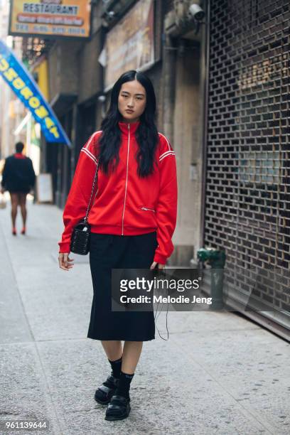 Model Jing Wen wears a red jacket, black skirt, black Supreme socks, and black Chanel sandals during New York Fashion Week Spring/Summer 2018 on...