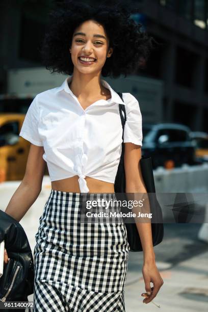 Model Damaris Goddrie wears a shirt tied at the waist and black and white gingham skirt during New York Fashion Week Spring/Summer 2018 on September...