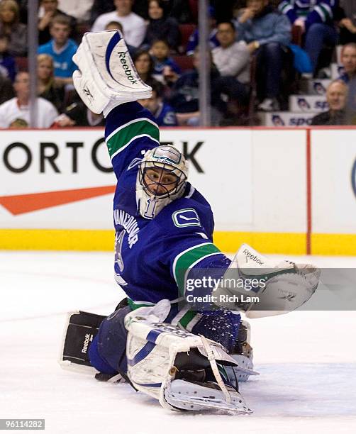 Goalie Roberto Luongo of the Vancouver Canucks reaches out to make a glove save during the third period of NHL action against the Chicago Blackhawks...