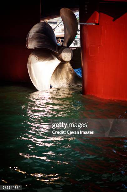 close-up of propeller on container ship in water - ship propeller stock pictures, royalty-free photos & images
