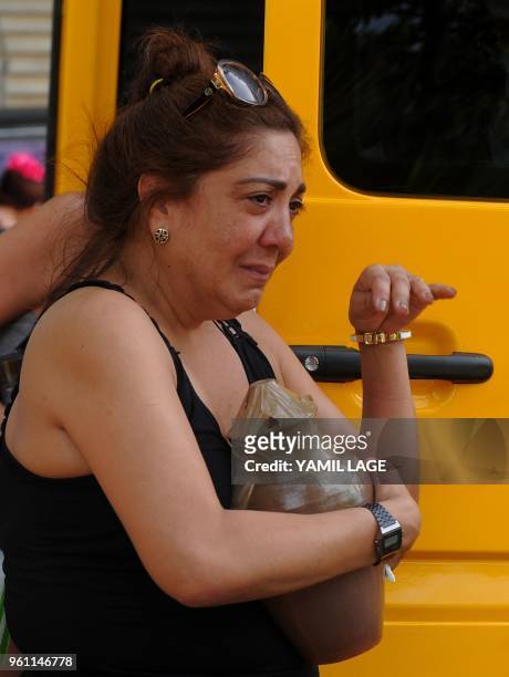 Relatives of one of the victims of the plane crash in Havana that killed 110 people, cries as she leaves a funeral parlour in Havana on May 21, 2018...