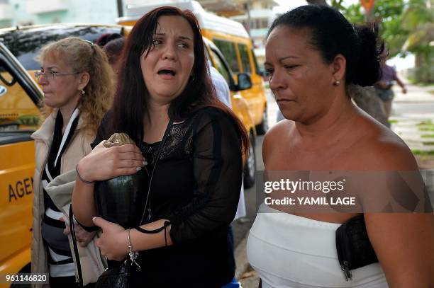 Relatives of one of the victims of the plane crash in Havana that killed 110 people, cries as she leaves a funeral parlour in Havana on May 21, 2018...