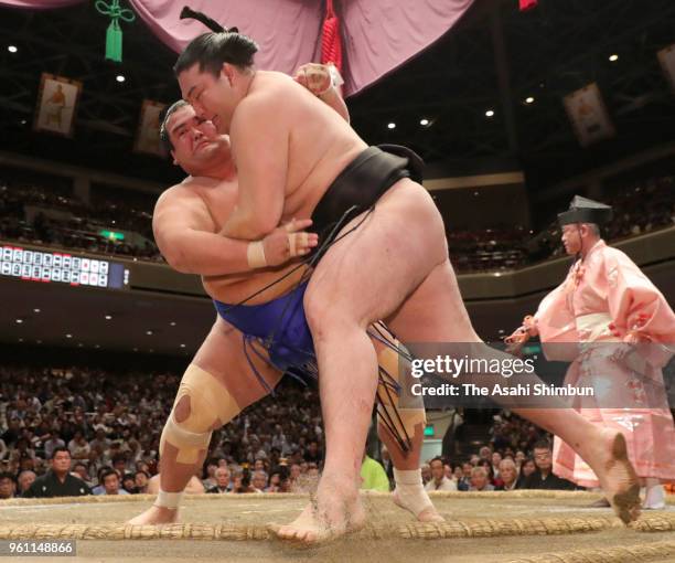 Kotoshogiku pushes Ryuden out of the ring to win on day seven of the Grand Sumo Summer Tournament at Ryogoku Kokugikan on May 19, 2018 in Tokyo,...