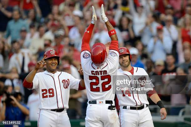Juan Soto of the Washington Nationals celebrates with Pedro Severino and Mark Reynolds after hitting a home run in the second inning for his first...