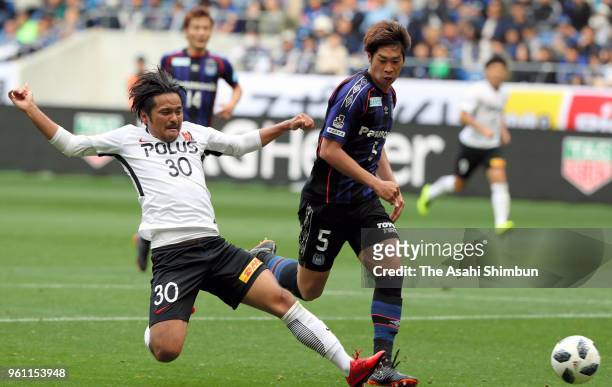 Shinzo Koroki of Urawa Red Diamonds and Genta Miura of Gamba Osaka compete for the ball during the J.League J1 match between Gamba Osaka and Urawa...