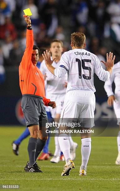 Team captain Jimmy Conrad receives his first yellow card from the referee before eventally being sent off during their international friendly against...