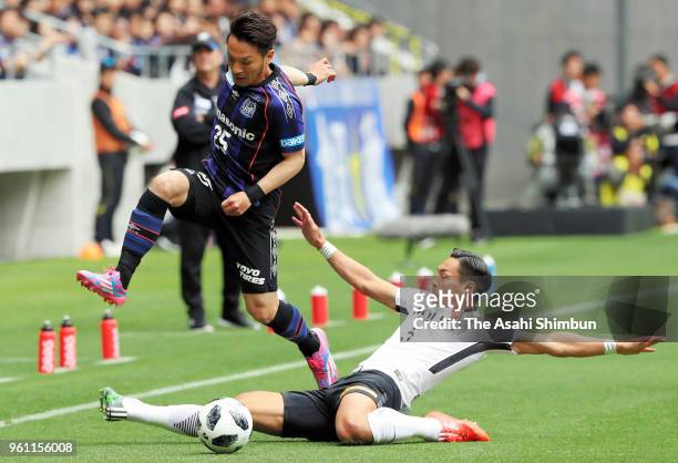 Jungo Fujimoto of Gamba Osaka is tackled by Tomoaki Makino of Urawa Red Diamodns during the J.League J1 match between Gamba Osaka and Urawa Red...