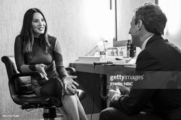 Episode 690 -- Pictured: Actress Olivia Munn talks with host Seth Meyers backstage on May 21, 2018 --